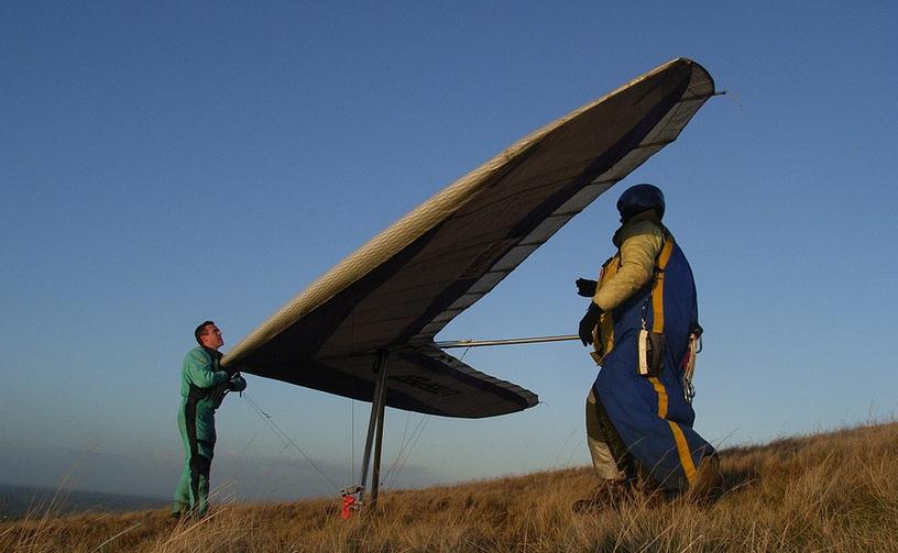 people getting ready for hang gliding