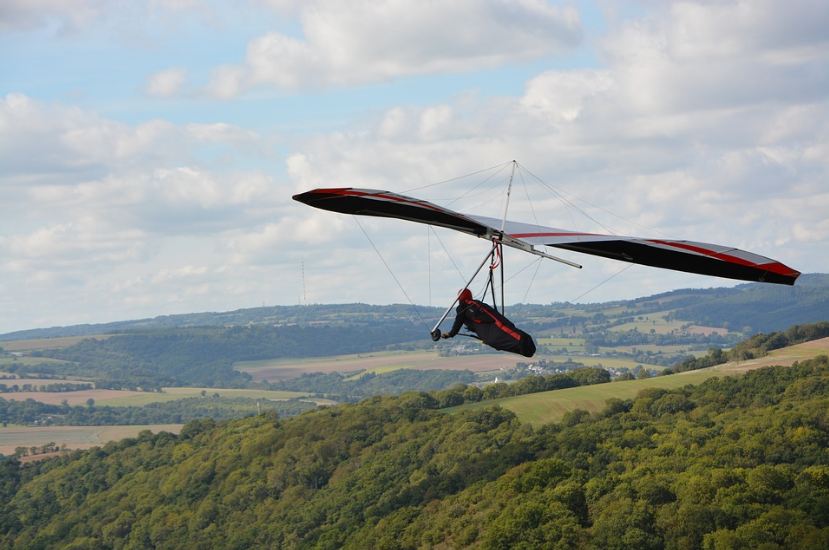 person hang gliding, back view of hang-glider