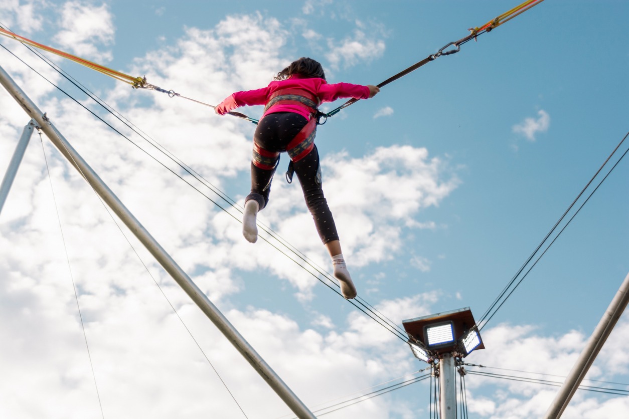 Girl is jumping on a bungee trampoline