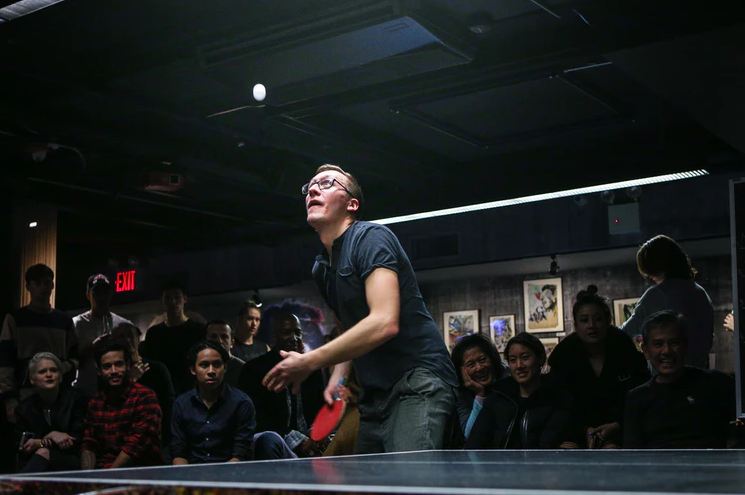 a man about paddle a ping pong ball