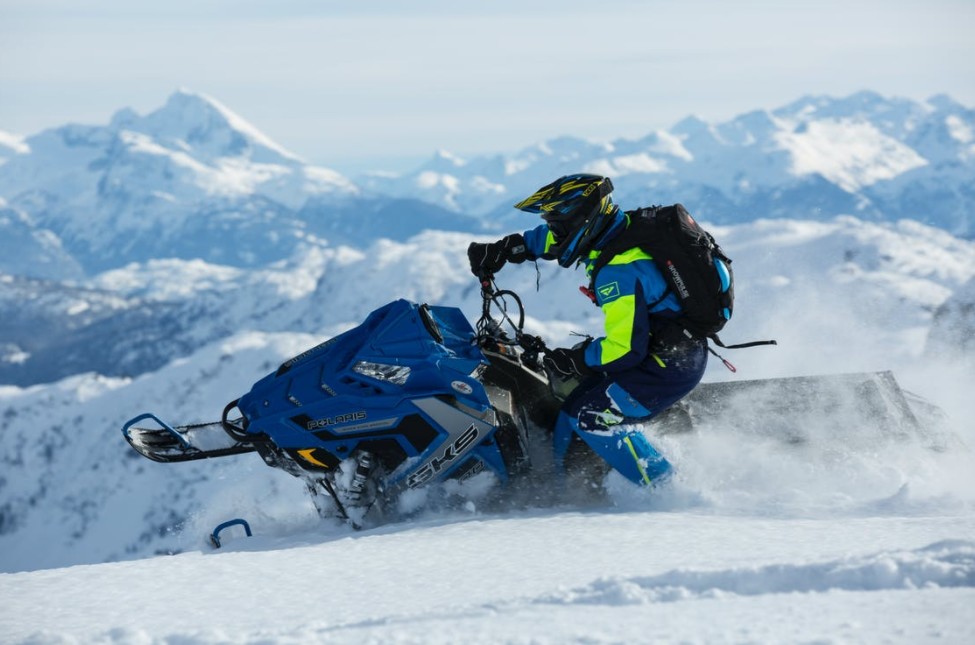 a man riding on a snow mobile