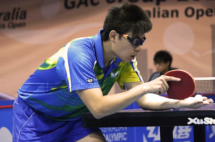 a table tennis player serving a shot