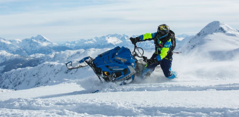 a man riding blue snow ski scooter