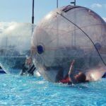 Children Inside the Water Ball on the Pool