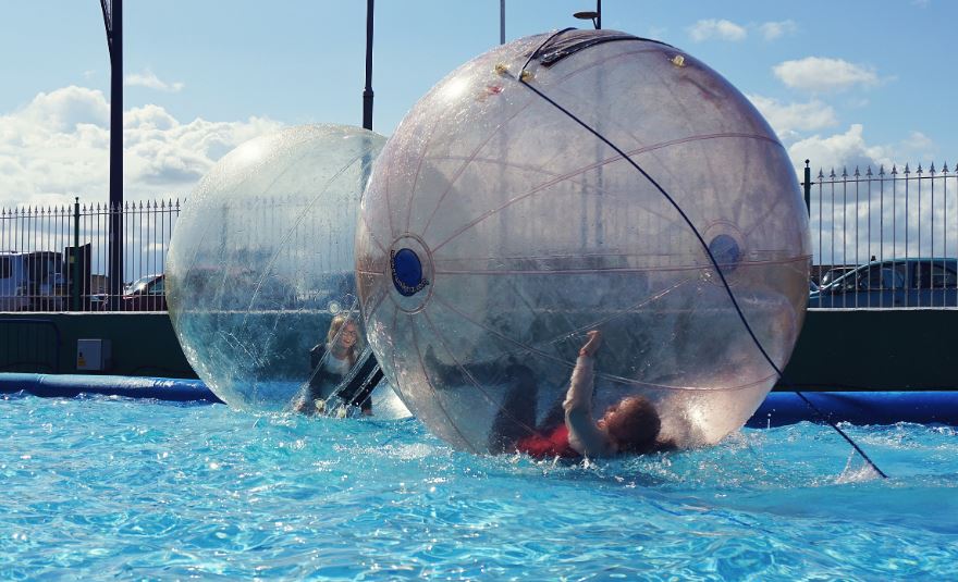 Children Inside the Water Ball on the Pool