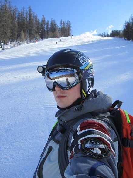 A man wearing a snow jacket with helmet