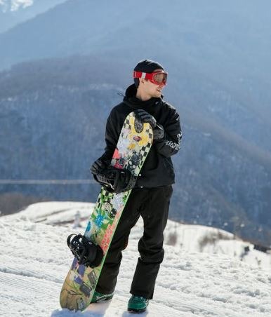 man holding his snowboard